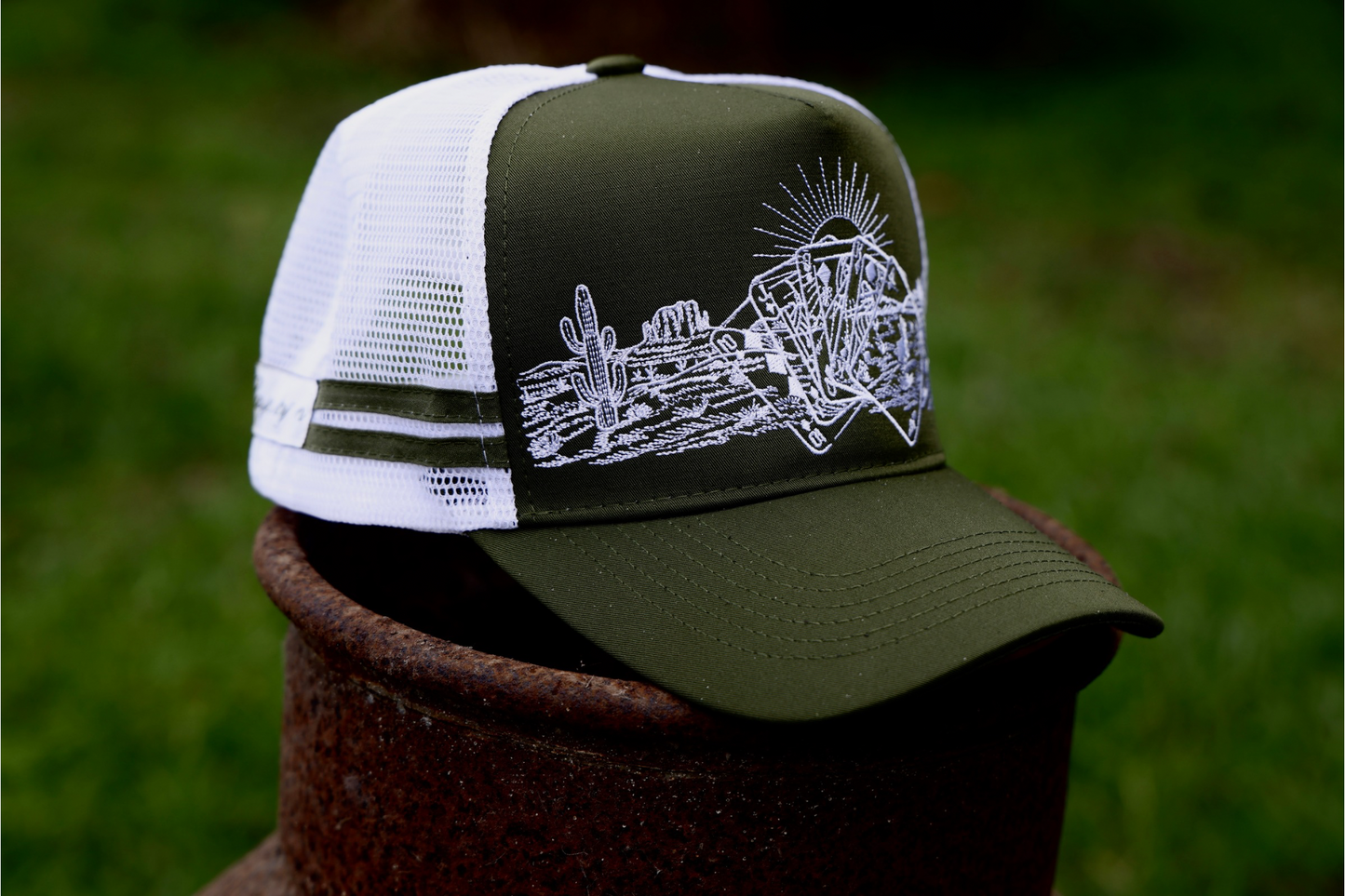 khaki green cap with with mesh & SnapBack. 
White embroidered desert pattern with cards overlaid. 