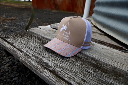 Cream Trucker Cap.

Embroidered original Bucking Branded logo on front panel.
Cream, blue & peach aztec pattern on and under brim.
White mesh & snapback.